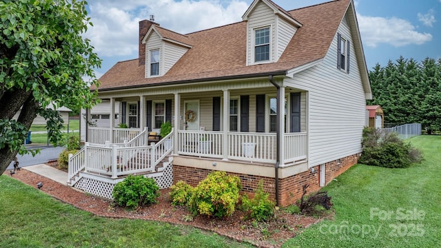139 Pleasant Garden Dr, Taylorsville, NC 28681 - cape cod-style house featuring covered porch, a front lawn, a chimney, and roof with shingles