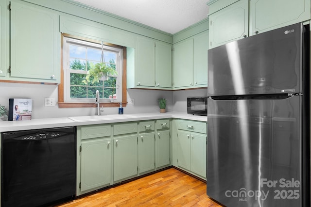 139 Pleasant Garden Dr, Taylorsville, NC 28681 - kitchen with black appliances, a sink, green cabinets, and light countertops