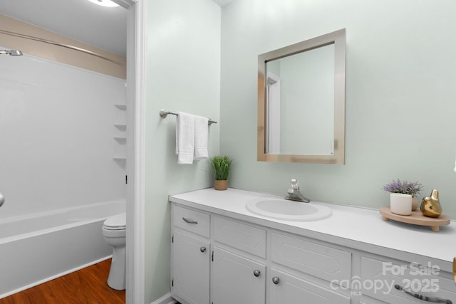 139 Pleasant Garden Dr, Taylorsville, NC 28681 - bathroom with vanity, wood finished floors, toilet, and  shower combination