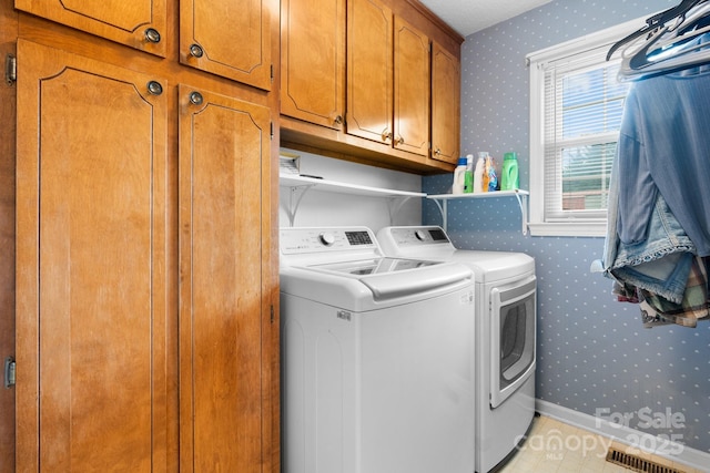 139 Pleasant Garden Dr, Taylorsville, NC 28681 - laundry room with wallpapered walls, washer and dryer, and cabinet space