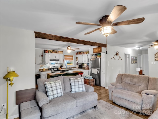 49 Trimont Mountain Trl, Franklin, NC 28734 - living room with a ceiling fan, light wood finished floors, beam ceiling, and baseboards