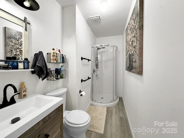 49 Trimont Mountain Trl, Franklin, NC 28734 - bathroom with a stall shower, wood finished floors, toilet, and vanity