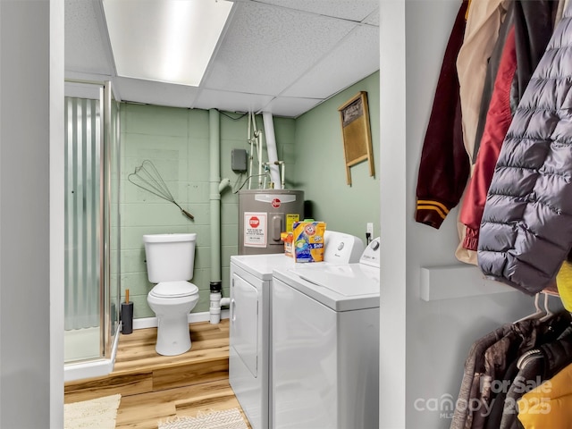 49 Trimont Mountain Trl, Franklin, NC 28734 - washroom featuring washing machine and clothes dryer, electric water heater, and light wood finished floors