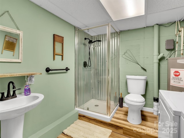 49 Trimont Mountain Trl, Franklin, NC 28734 - bathroom featuring washer / dryer, a stall shower, toilet, wood finished floors, and a sink