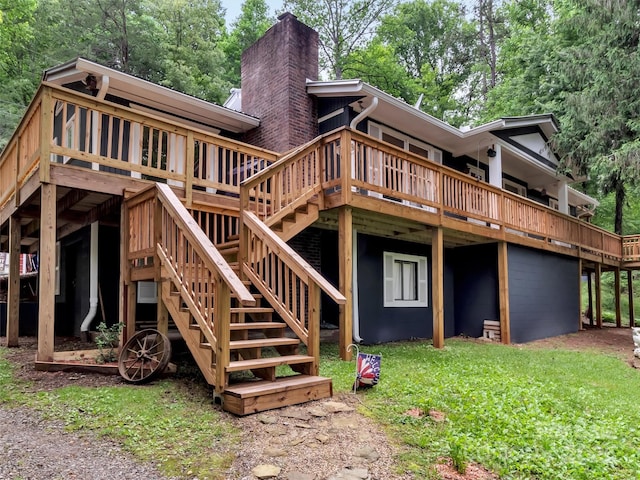49 Trimont Mountain Trl, Franklin, NC 28734 - rear view of house with a chimney, a deck, and a lawn