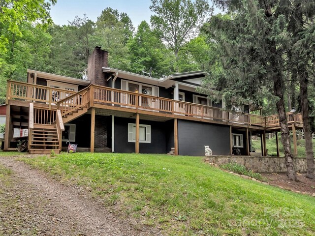 49 Trimont Mountain Trl, Franklin, NC 28734 - back of property featuring a chimney, a deck, a yard, and stairs