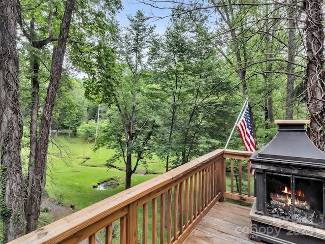 49 Trimont Mountain Trl, Franklin, NC 28734 - wooden deck with a warm lit fireplace and a lawn