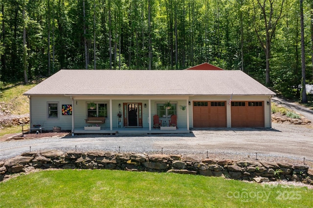 33 Freedom Dr, Waynesville, NC 28786 - view of front of property featuring a porch, a garage, dirt driveway, and a front yard