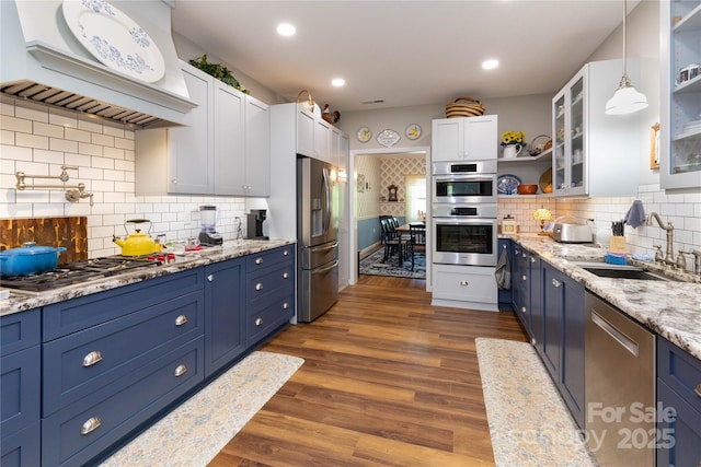 33 Freedom Dr, Waynesville, NC 28786 - kitchen featuring appliances with stainless steel finishes, open shelves, blue cabinets, a sink, and custom range hood