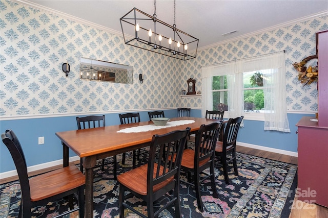 33 Freedom Dr, Waynesville, NC 28786 - dining area featuring crown molding, wood finished floors, a chandelier, wallpapered walls, and baseboards