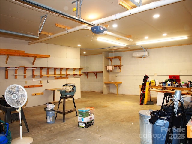 33 Freedom Dr, Waynesville, NC 28786 - garage featuring a workshop area, a garage door opener, a wall mounted AC, and concrete block wall