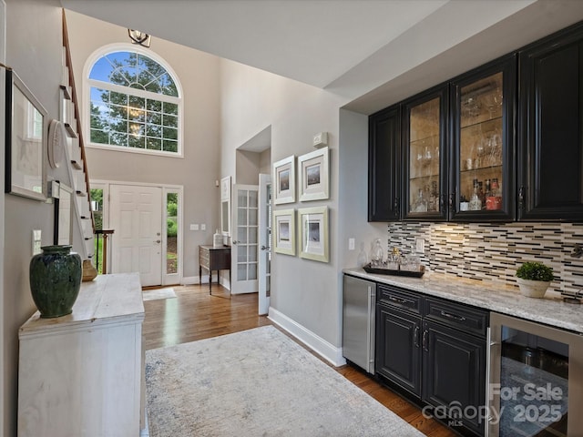 16308 Woolwine Rd, Charlotte, NC 28278 - indoor dry bar featuring beverage cooler, dark wood-style floors, backsplash, baseboards, and fridge