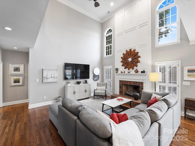 16308 Woolwine Rd, Charlotte, NC 28278 - living room featuring a high ceiling, baseboards, a brick fireplace, crown molding, and wood finished floors