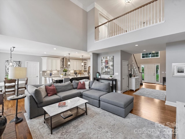 16308 Woolwine Rd, Charlotte, NC 28278 - living room with wood finished floors, baseboards, a towering ceiling, ornamental molding, and a chandelier