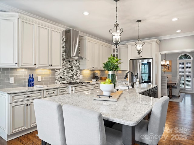 16308 Woolwine Rd, Charlotte, NC 28278 - kitchen featuring stainless steel appliances, wall chimney exhaust hood, a sink, backsplash, and a center island with sink