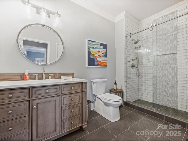 16308 Woolwine Rd, Charlotte, NC 28278 - bathroom featuring ornamental molding, toilet, vanity, tiled shower, and tile patterned flooring