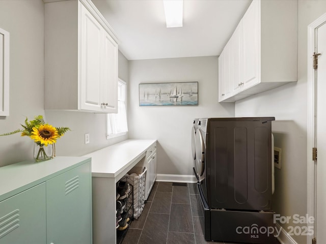 16308 Woolwine Rd, Charlotte, NC 28278 - laundry area with cabinet space, washing machine and dryer, baseboards, and dark tile patterned floors