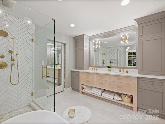 16308 Woolwine Rd, Charlotte, NC 28278 - full bath with a stall shower, double vanity, a freestanding tub, tile patterned floors, and a chandelier