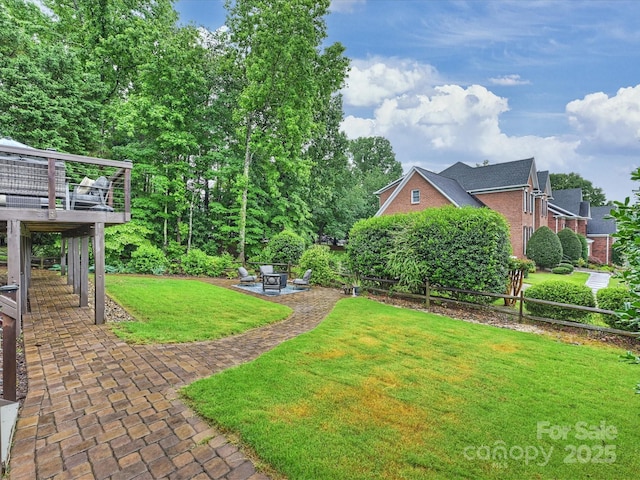 16308 Woolwine Rd, Charlotte, NC 28278 - view of green lawn with a patio area, a wooden deck, and a fire pit