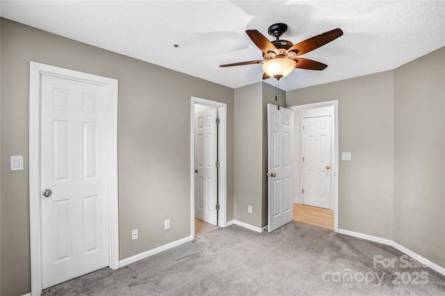 753 SW Dr, Davidson, NC 28036 - unfurnished bedroom with carpet flooring, baseboards, a textured ceiling, and ceiling fan