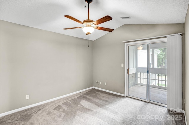 753 SW Dr, Davidson, NC 28036 - spare room with carpet flooring, ceiling fan, vaulted ceiling, baseboards, and a textured ceiling