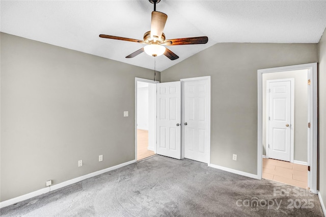 753 SW Dr, Davidson, NC 28036 - unfurnished bedroom featuring carpet, baseboards, lofted ceiling, and ceiling fan