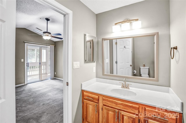 753 SW Dr, Davidson, NC 28036 - bathroom featuring vanity, ceiling fan, a textured ceiling, lofted ceiling, and toilet