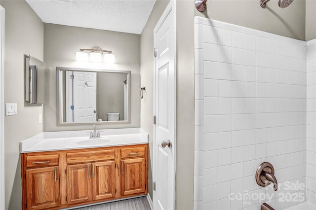 753 SW Dr, Davidson, NC 28036 - bathroom featuring toilet, vanity, shower / washtub combination, and a textured ceiling