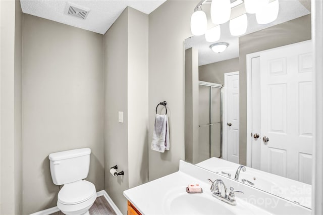 753 SW Dr, Davidson, NC 28036 - full bath with baseboards, toilet, a shower stall, vanity, and a textured ceiling