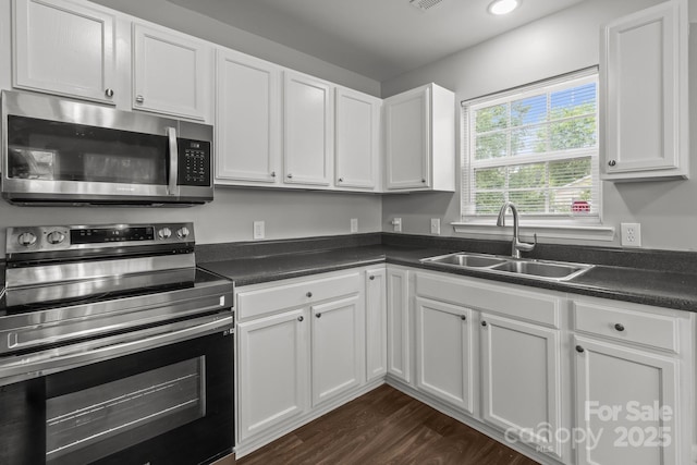 252 Sweet Bay Ln NW, Concord, NC 28027 - kitchen with appliances with stainless steel finishes, a sink, dark countertops, white cabinetry, and recessed lighting
