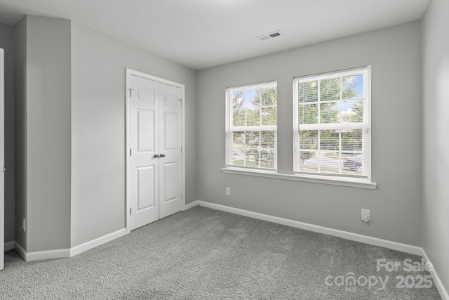 252 Sweet Bay Ln NW, Concord, NC 28027 - unfurnished bedroom featuring carpet, baseboards, and a closet