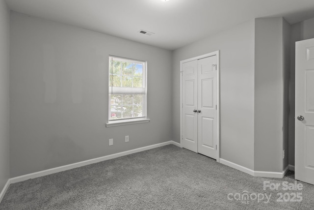 252 Sweet Bay Ln NW, Concord, NC 28027 - unfurnished bedroom with carpet floors, baseboards, and a closet