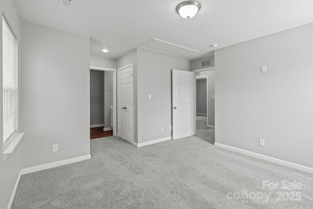 252 Sweet Bay Ln NW, Concord, NC 28027 - unfurnished bedroom featuring attic access, baseboards, and carpet flooring