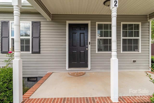 252 Sweet Bay Ln NW, Concord, NC 28027 - view of exterior entry with crawl space and a porch
