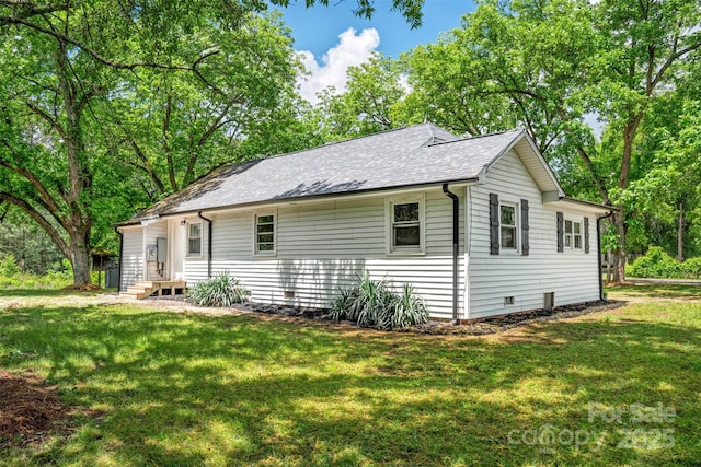 615 Irish Potato Rd, Concord, NC 28025 - view of side of property featuring a yard and roof with shingles