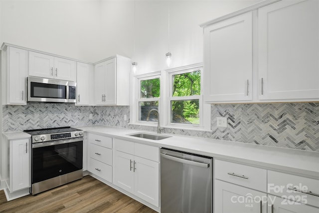 615 Irish Potato Rd, Concord, NC 28025 - kitchen with stainless steel appliances, a sink, light countertops, and backsplash
