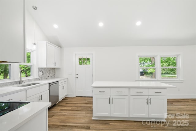 615 Irish Potato Rd, Concord, NC 28025 - kitchen with dishwasher, a sink, light countertops, white cabinets, and wood finished floors