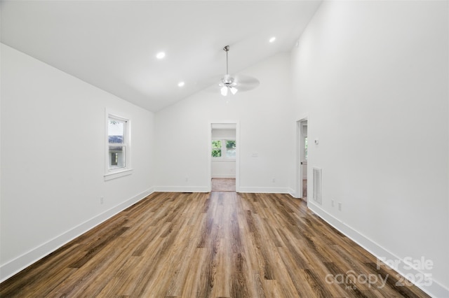 615 Irish Potato Rd, Concord, NC 28025 - unfurnished living room with wood finished floors, a ceiling fan, baseboards, recessed lighting, and high vaulted ceiling