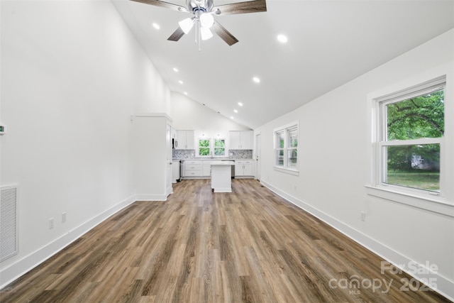 615 Irish Potato Rd, Concord, NC 28025 - unfurnished living room with a ceiling fan, wood finished floors, recessed lighting, high vaulted ceiling, and baseboards