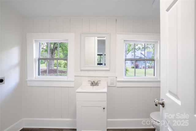 615 Irish Potato Rd, Concord, NC 28025 - half bath with a decorative wall, vanity, and toilet