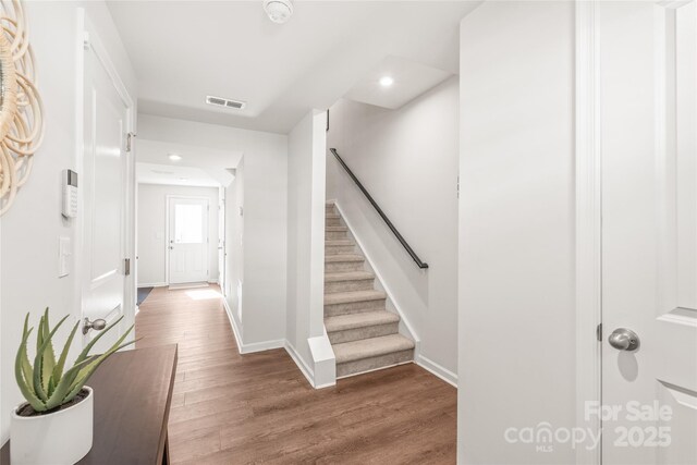 5023 Daybell St, Charlotte, NC 28214 - foyer entrance with wood finished floors, baseboards, recessed lighting, and stairs