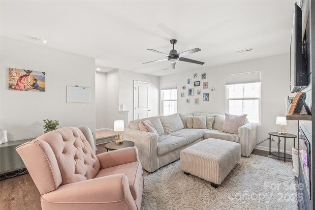 5023 Daybell St, Charlotte, NC 28214 - living area featuring light wood-style floors, healthy amount of natural light, ceiling fan, and baseboards