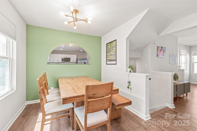 5023 Daybell St, Charlotte, NC 28214 - dining room with wood finished floors, a chandelier, and baseboards