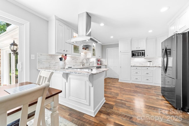 120 Labans Ln, Lincolnton, NC 28092 - kitchen with appliances with stainless steel finishes, a peninsula, island range hood, ornamental molding, and decorative backsplash