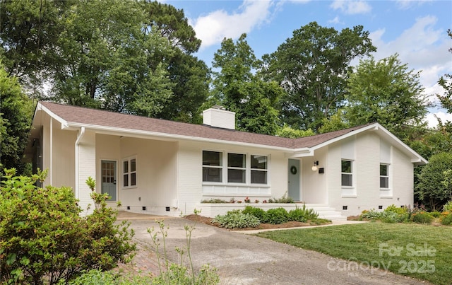 4017 Sulkirk Rd, Charlotte, NC 28210 - single story home with a chimney, brick siding, concrete driveway, a front lawn, and a carport