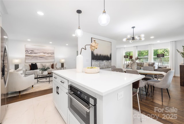 4017 Sulkirk Rd, Charlotte, NC 28210 - kitchen featuring open floor plan, stainless steel appliances, white cabinets, a chandelier, and recessed lighting