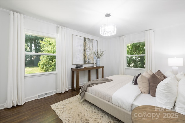 4017 Sulkirk Rd, Charlotte, NC 28210 - bedroom featuring dark wood-style flooring, a chandelier, and baseboards
