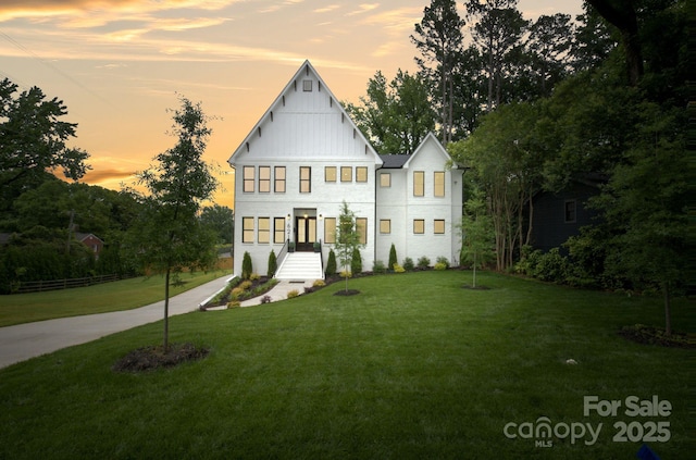 621 Poindexter Dr, Charlotte, NC 28209 - view of front facade featuring a yard, board and batten siding, and view of scattered trees
