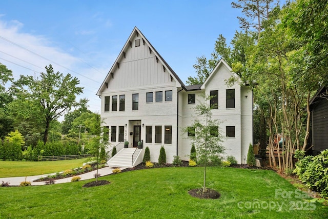 621 Poindexter Dr, Charlotte, NC 28209 - back of house featuring board and batten siding and a lawn