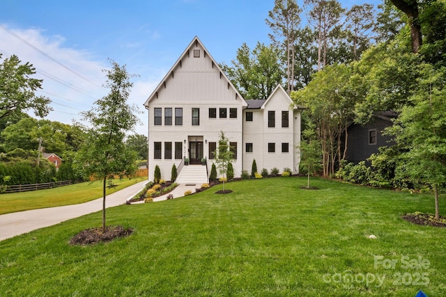 621 Poindexter Dr, Charlotte, NC 28209 - view of front facade with a front lawn and board and batten siding